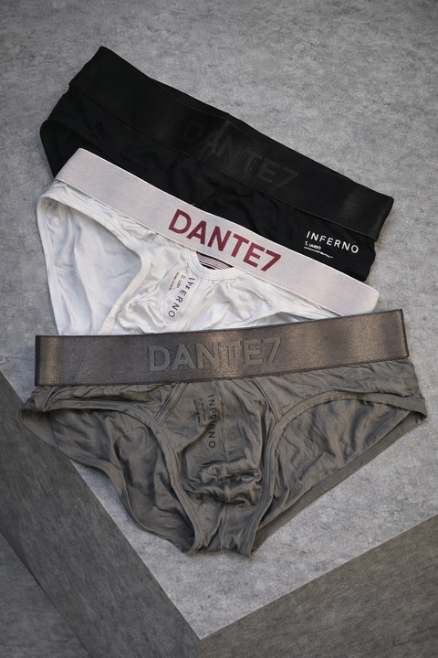 Three pairs of underwear from the brand 'Dante7' on a gray surface.