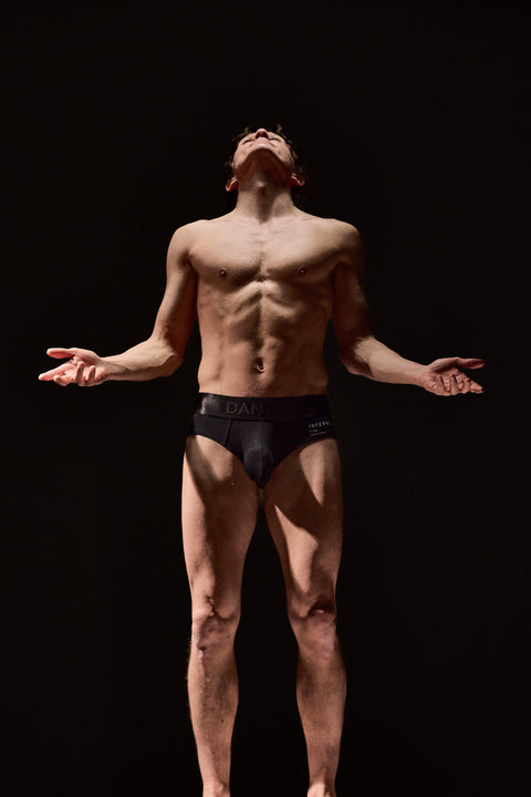 Man standing on a pedestal with a dark background