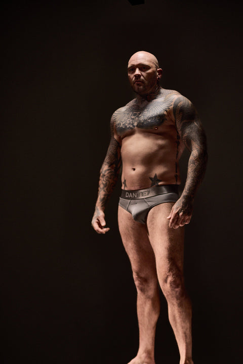 Man standing on a pedestal against a dark background